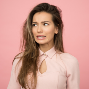 Unconfident woman in pink looking left